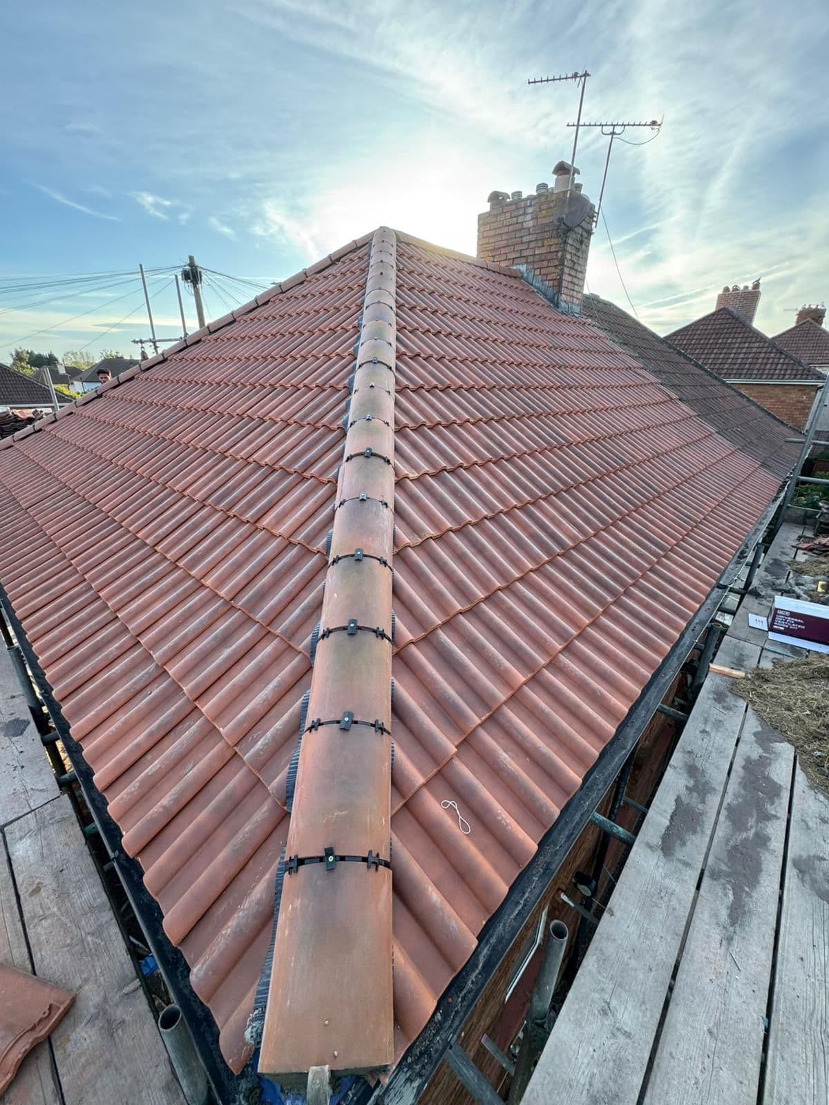 New pitched roof installation showing quality tiling and ridge detail