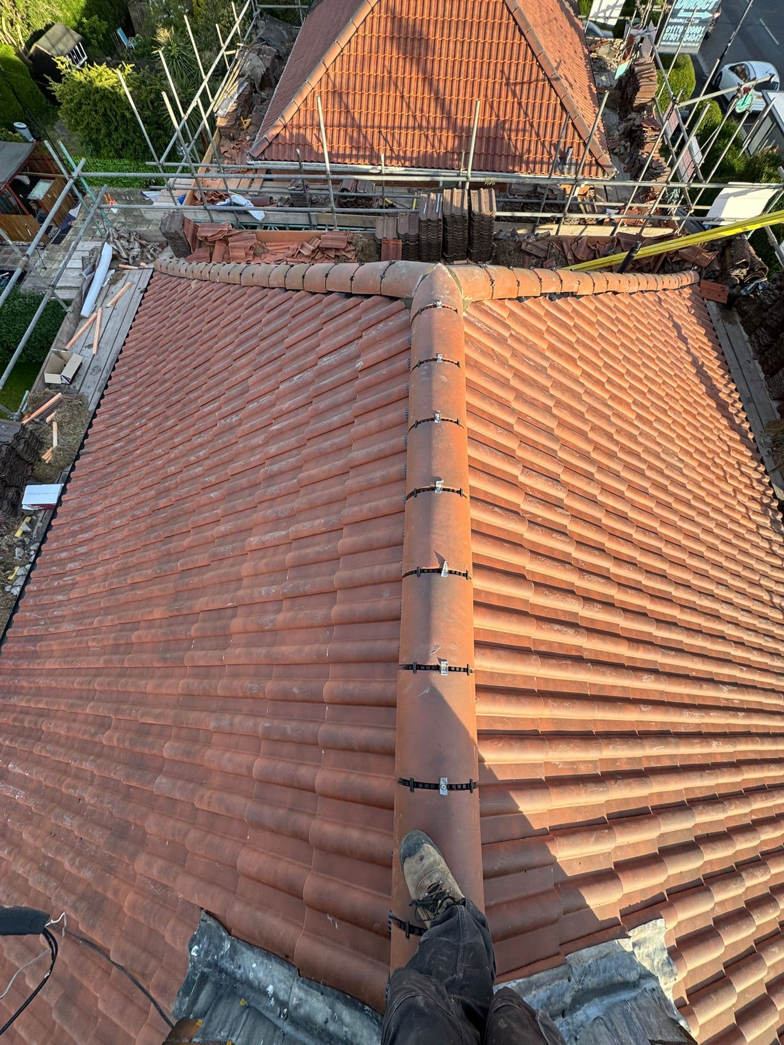 Pitched roof replacement in progress — new felt, battens, and tiles fitted throughout