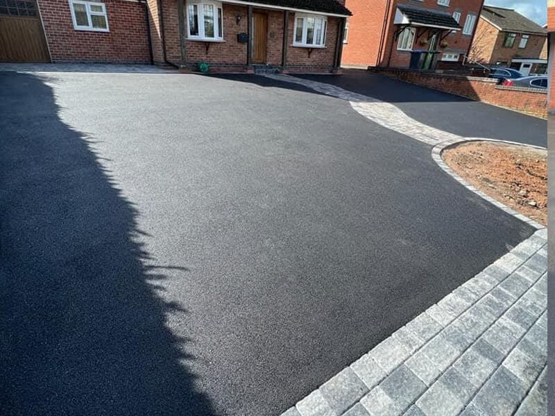New tarmac driveway laid at the front of a Bristol home — clean finish with block paving border