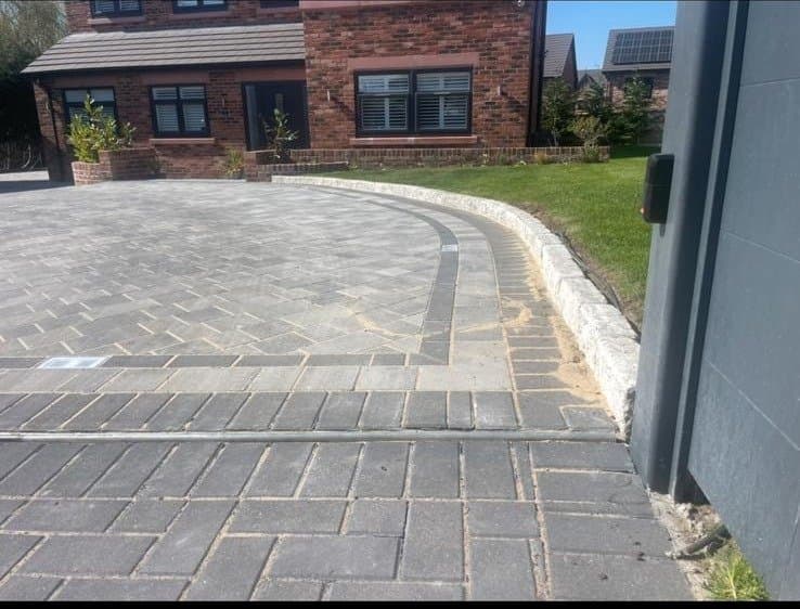 Grey porcelain patio with matching steps to a conservatory